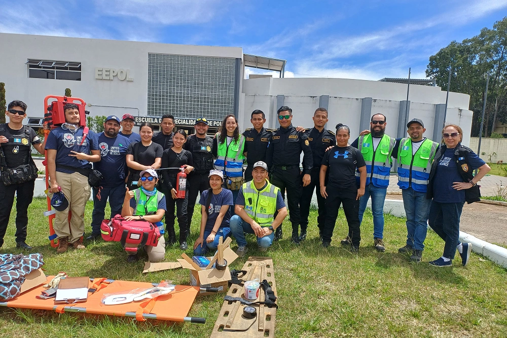 Large group of dental professionals and staff posing outdoors at community event with equipment displayed.