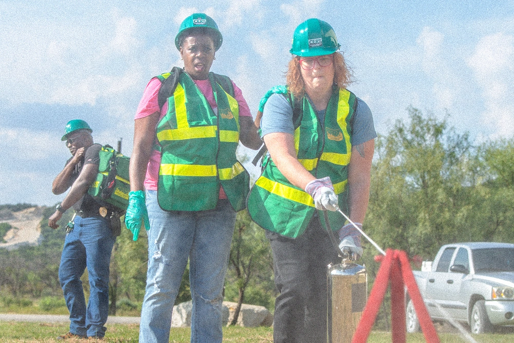 Construction workers in safety gear and hard hats at outdoor work site.