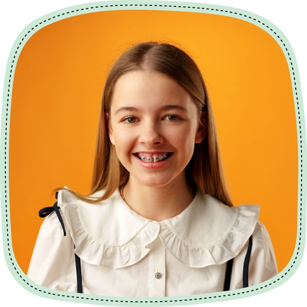 Smiling girl with healthy teeth wearing white collar shirt against orange background.